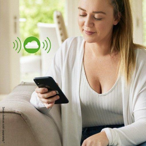 A woman using her mobile phone to share and follow her glucose data